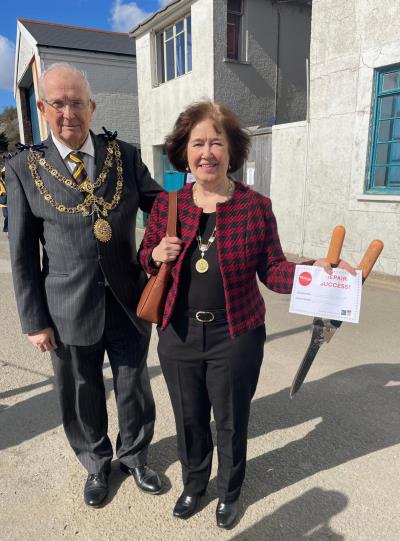 the Mayor Cllr Philip Evans MBE with mayoress Jackie Evans holding the sheers repaired at the repairs cafe