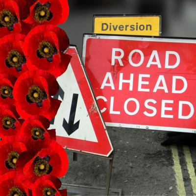 Road closure sign with red poppies to mark Remembrance parade road closures in Lyme Regis